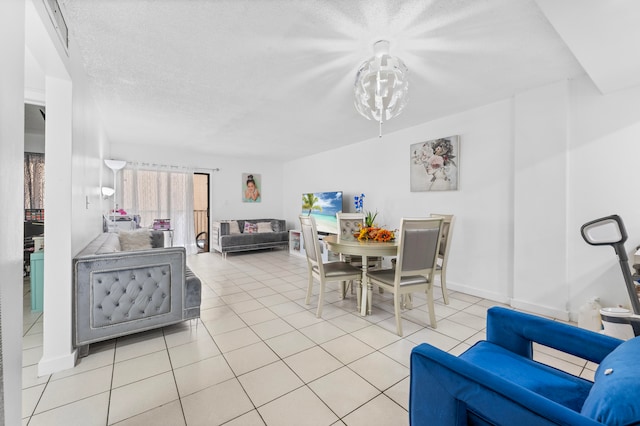 dining room featuring a textured ceiling and light tile patterned floors