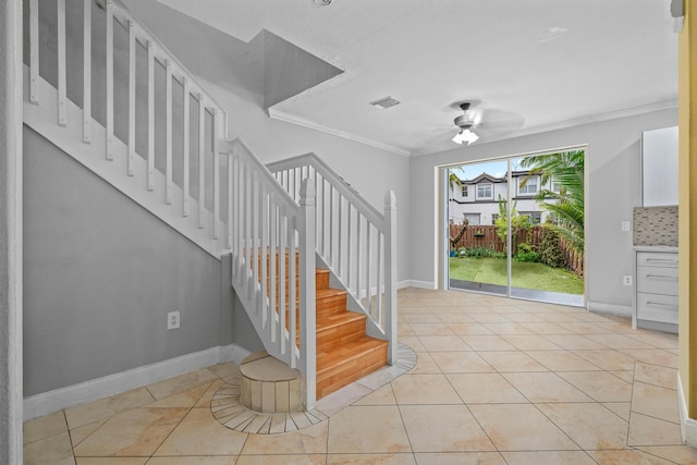 stairway featuring tile patterned flooring, crown molding, and ceiling fan