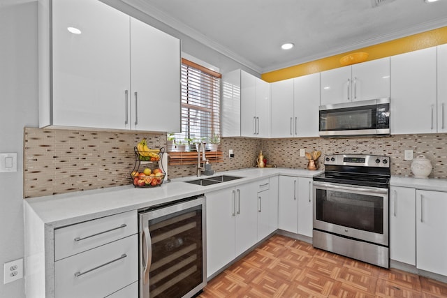 kitchen featuring wine cooler, sink, appliances with stainless steel finishes, decorative backsplash, and white cabinets