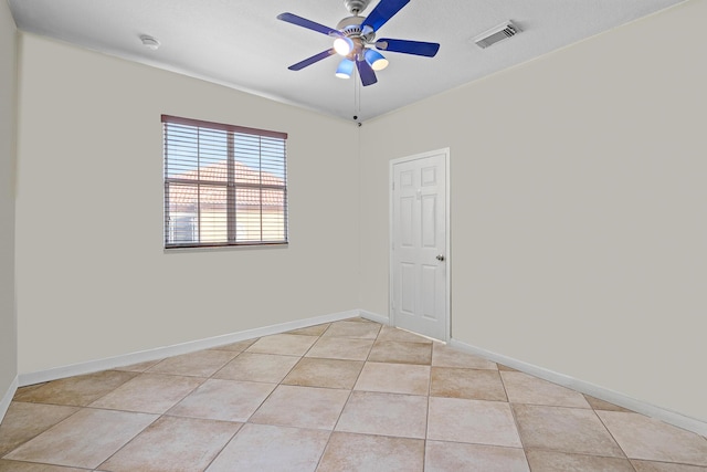 unfurnished room with ceiling fan and light tile patterned flooring