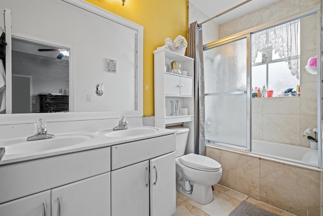 full bathroom with tile patterned floors, vanity, toilet, and tiled shower / bath combo