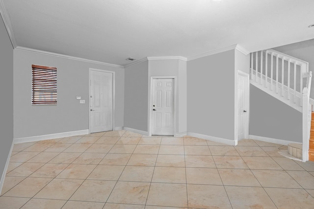 unfurnished room with crown molding and light tile patterned floors