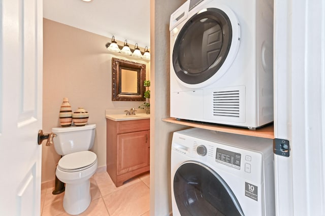 262 Monaco F, Delray Beach, FL 33446 - washroom featuring estacked washer and dryer and light tile patterned flooring