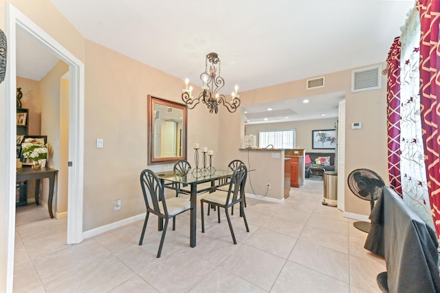 dining area featuring an inviting chandelier, light tile patterned flooring, baseboards, and visible vents