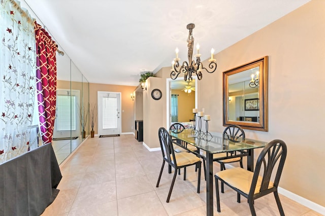 262 Monaco F, Delray Beach, FL 33446 - dining area featuring a chandelier, baseboards, light tile patterned floors, and a ceiling fan