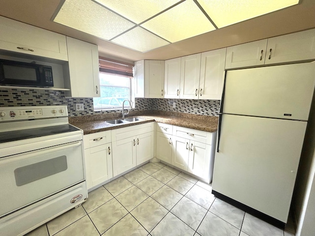 kitchen with backsplash, sink, white appliances, and white cabinetry