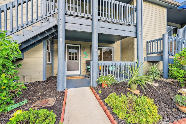 view of exterior entry featuring a balcony