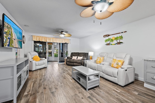 living room featuring ceiling fan and hardwood / wood-style flooring