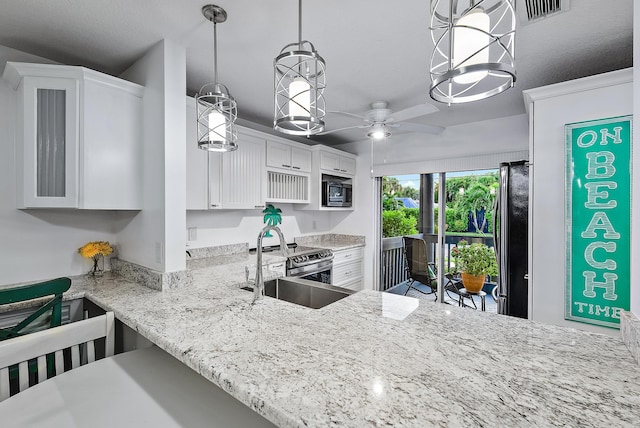 kitchen featuring appliances with stainless steel finishes, hanging light fixtures, sink, ceiling fan, and white cabinets