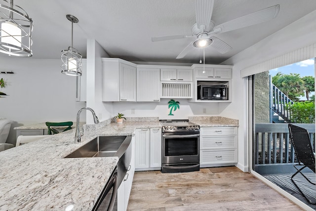 kitchen with stainless steel electric range oven, white cabinets, hanging light fixtures, light wood-type flooring, and black microwave