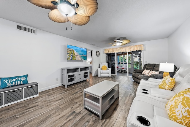 living room with wood-type flooring and ceiling fan