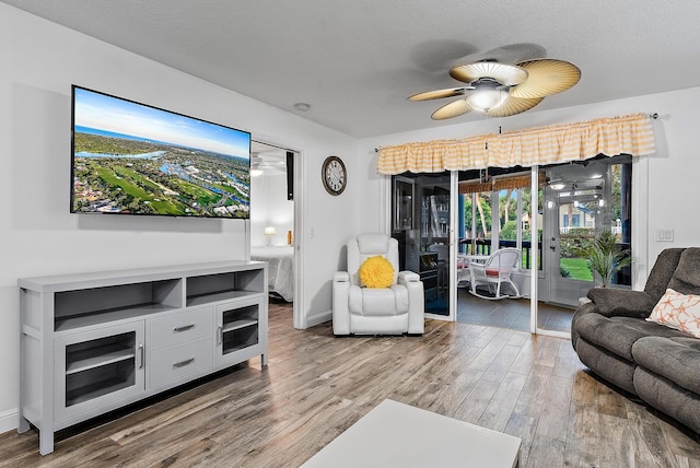 living room with hardwood / wood-style flooring and ceiling fan