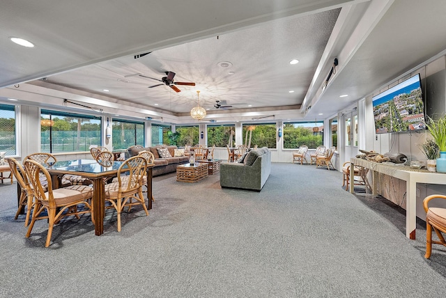 interior space with ceiling fan and a tray ceiling