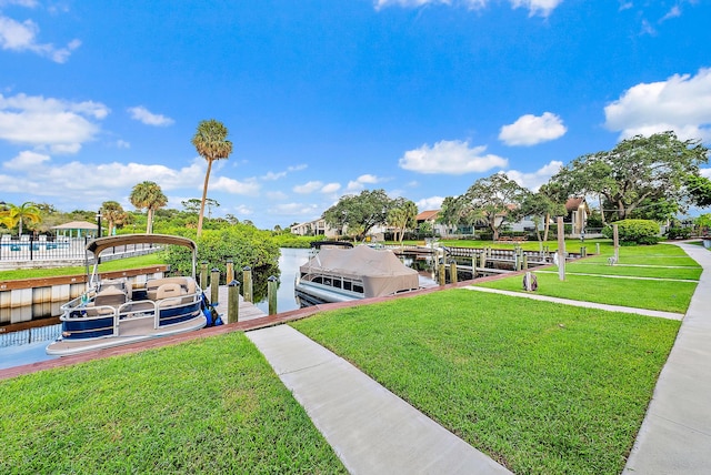 dock area with a water view and a yard