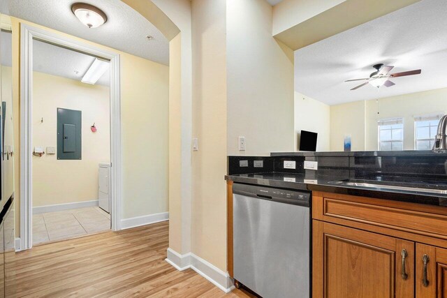 kitchen with dishwasher, light wood-type flooring, electric panel, sink, and ceiling fan