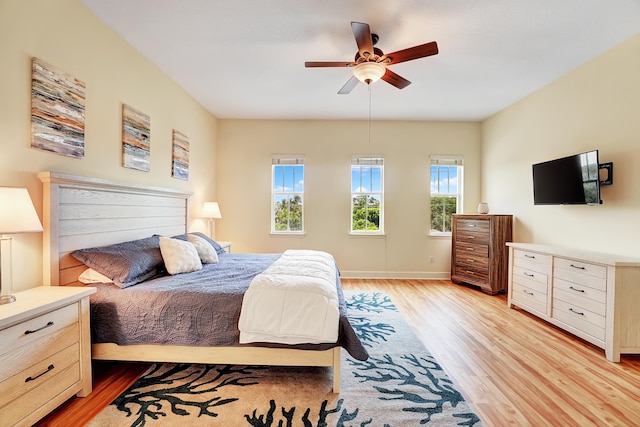 bedroom with light hardwood / wood-style flooring and ceiling fan