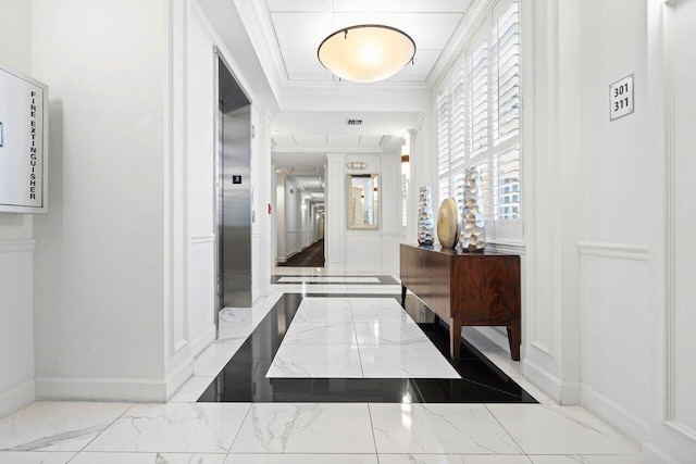 corridor featuring ornamental molding and elevator