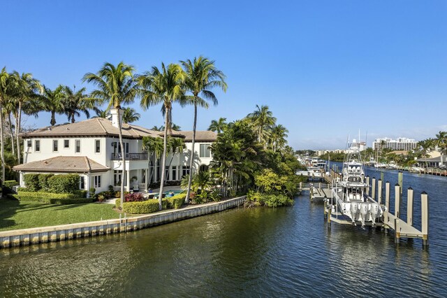 view of dock featuring a water view and a lawn