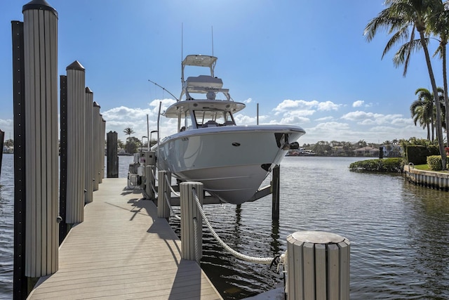 dock area with a water view and boat lift