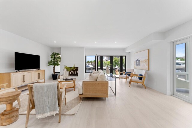 living room with french doors and light hardwood / wood-style flooring