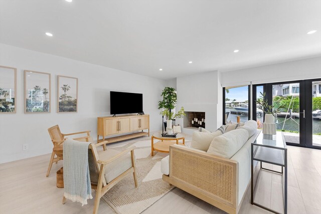 living room with french doors and light hardwood / wood-style flooring