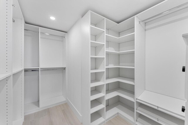 spacious closet with light hardwood / wood-style floors