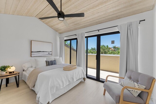 bedroom with access to exterior, ceiling fan, vaulted ceiling, and multiple windows