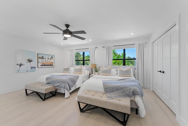 bedroom with light wood-type flooring and ceiling fan