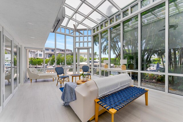 sunroom featuring a water view