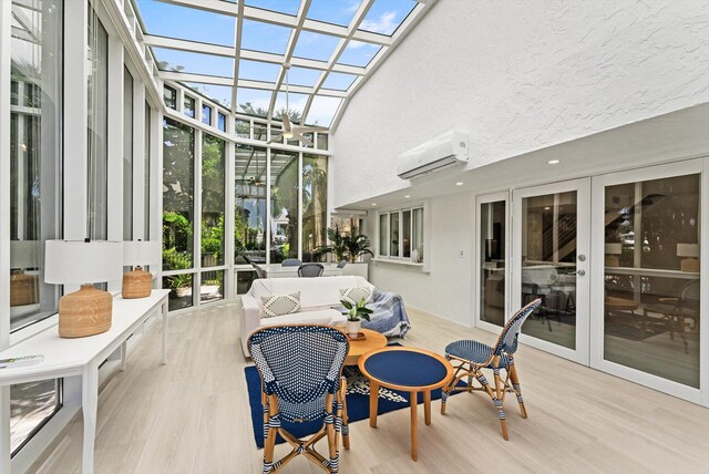 sunroom / solarium featuring a wealth of natural light, an AC wall unit, and french doors