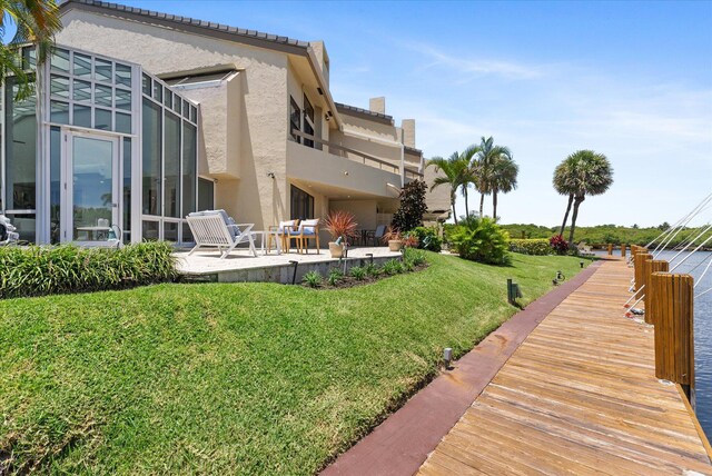 rear view of house with a yard and a patio area