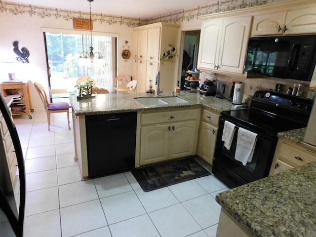 kitchen featuring cream cabinets, light stone counters, black appliances, pendant lighting, and sink