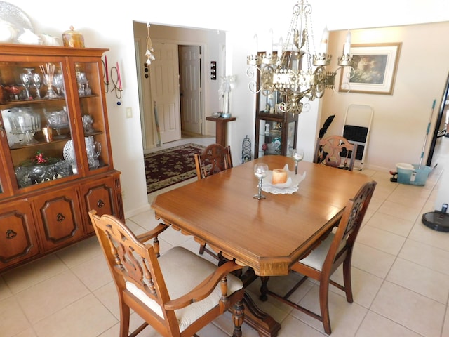 dining area featuring light tile patterned floors and an inviting chandelier