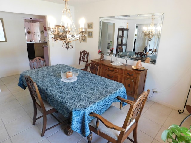 dining space with light tile patterned flooring and a notable chandelier