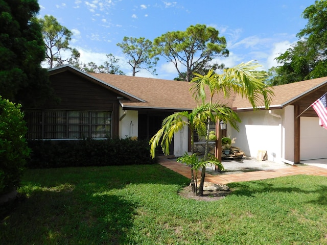 single story home featuring a front lawn and a garage