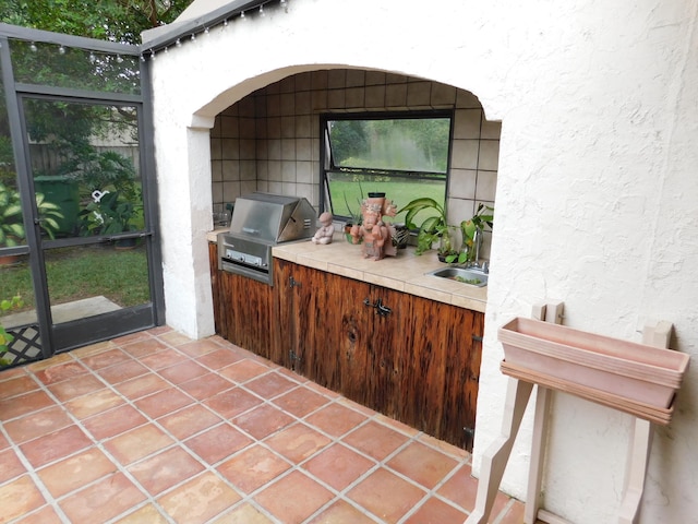 view of patio / terrace featuring an outdoor kitchen, sink, and grilling area