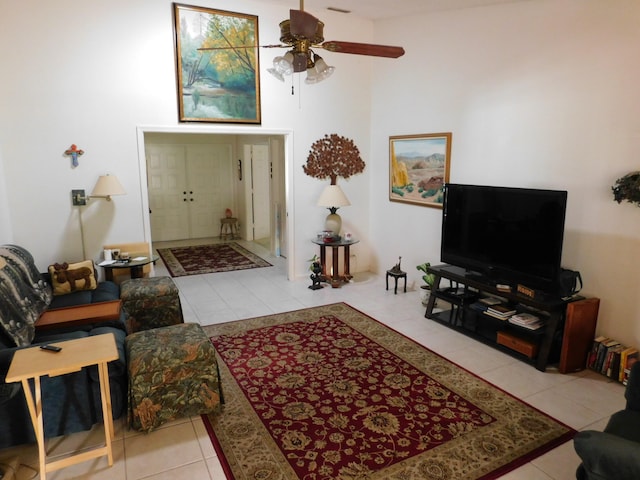 tiled living room with ceiling fan