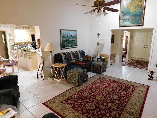 tiled living room with ceiling fan