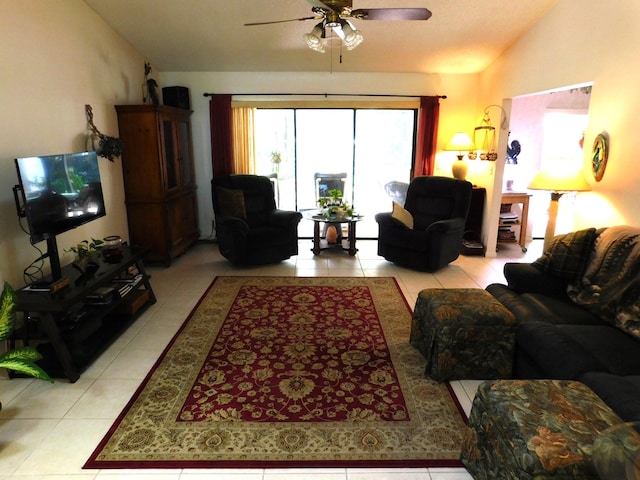 living room with lofted ceiling, light tile patterned floors, and ceiling fan