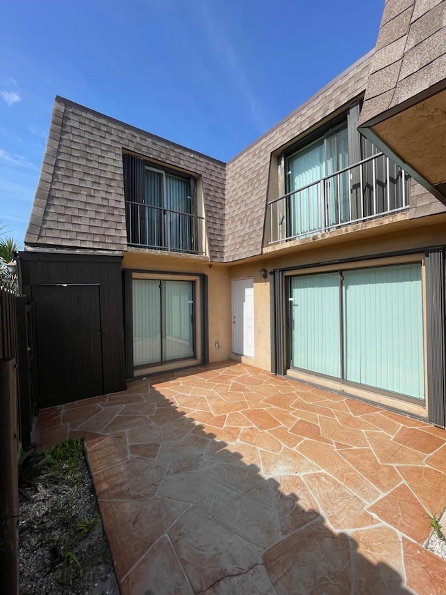 back of house with a patio