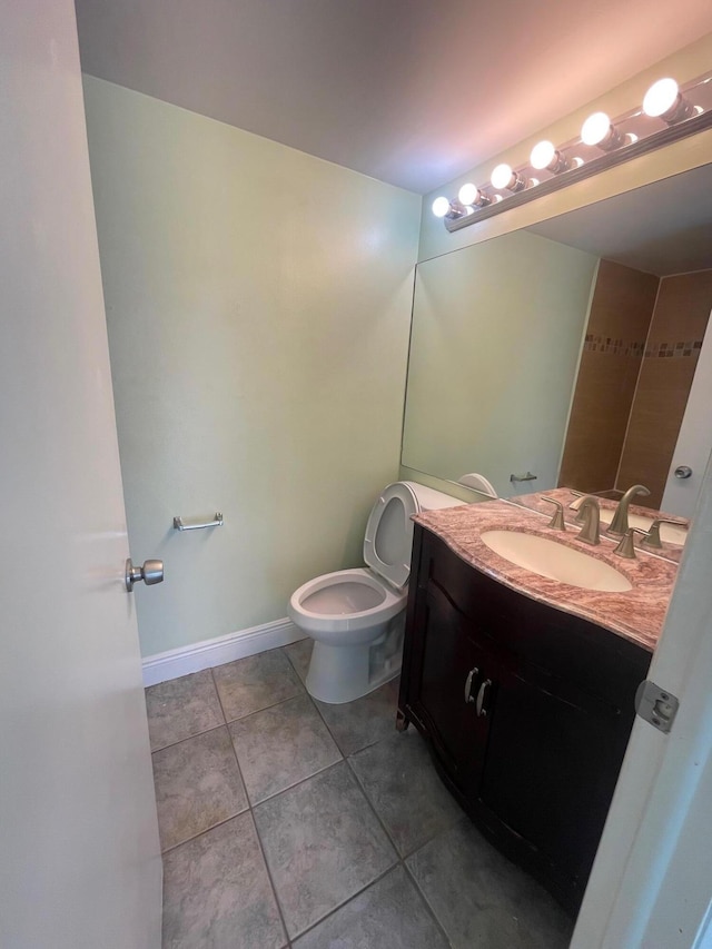 bathroom featuring tile patterned flooring, vanity, and toilet