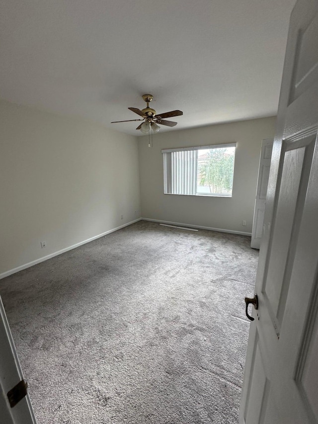 carpeted empty room with ceiling fan