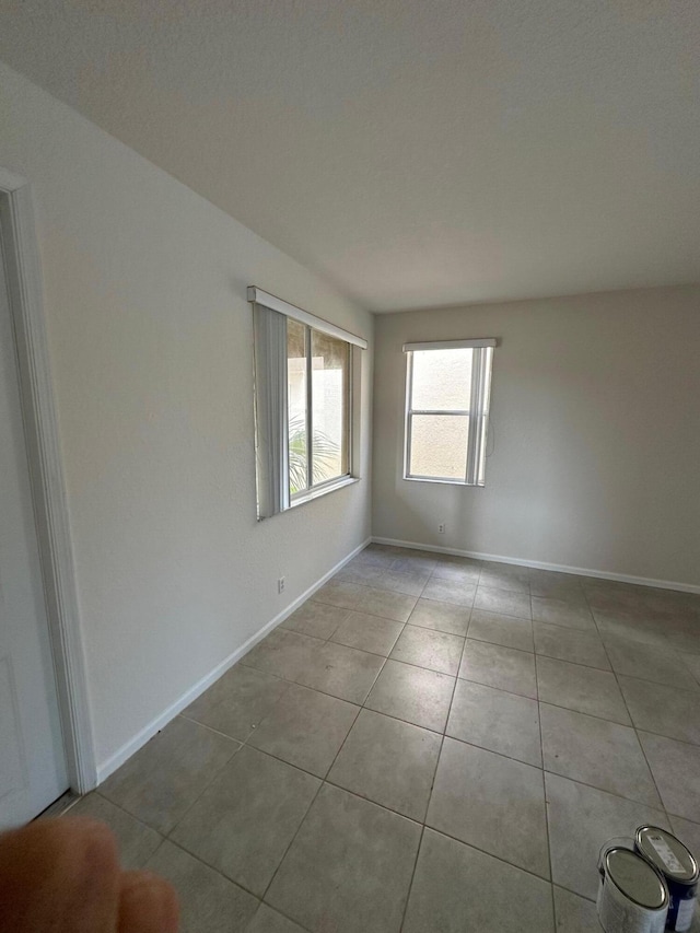 unfurnished room featuring light tile patterned floors