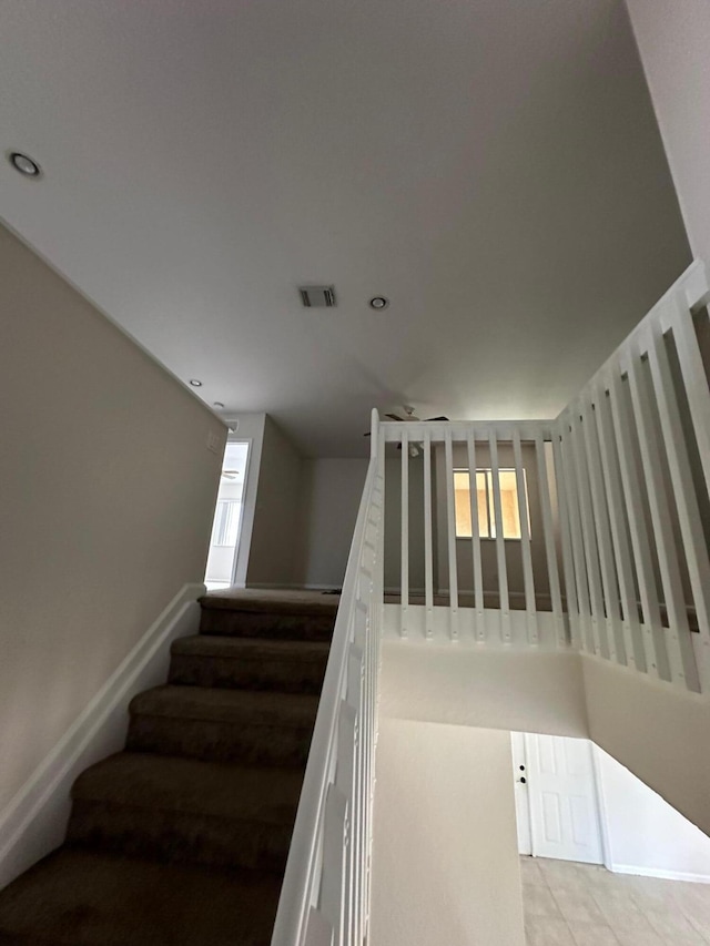 staircase with tile patterned floors