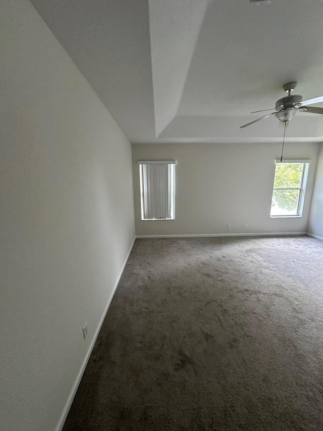 carpeted spare room with ceiling fan