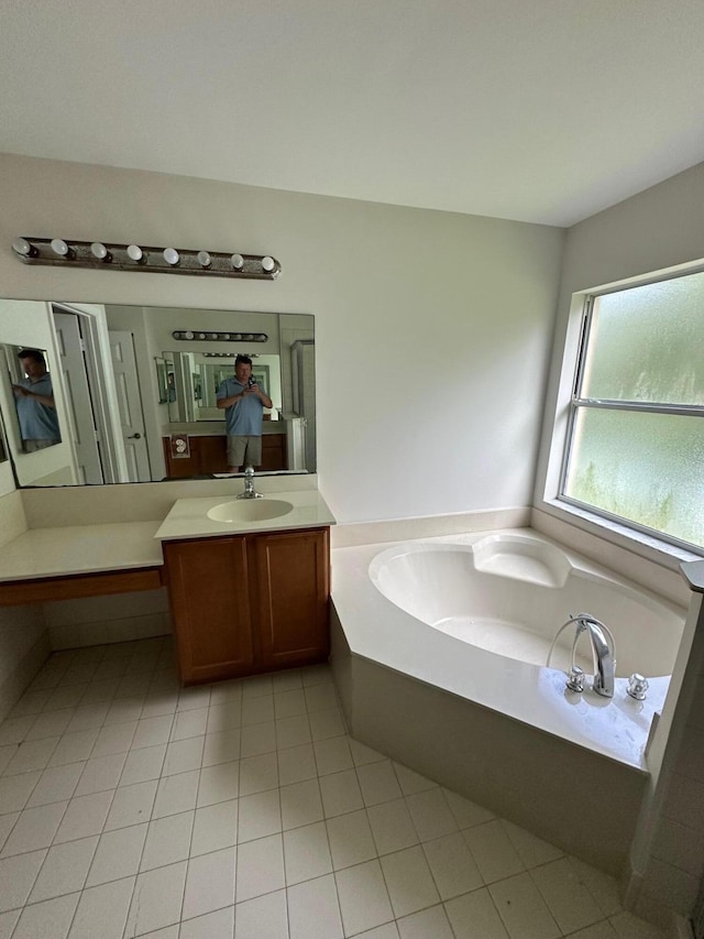 bathroom featuring tile patterned floors, a bathing tub, and vanity