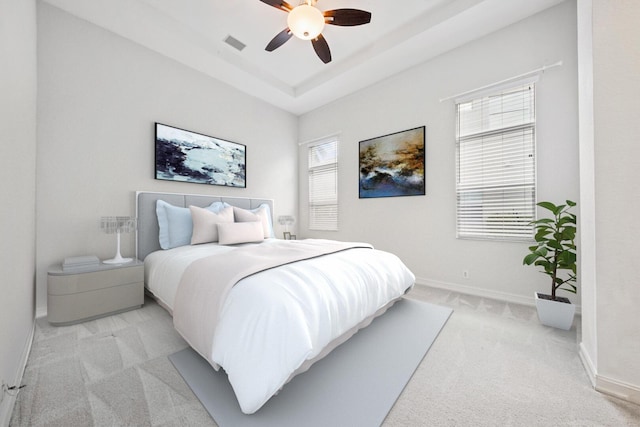 12520 NW 79th Mnr, Parkland, FL 33076 - bedroom with visible vents, baseboards, light colored carpet, a tray ceiling, and a ceiling fan