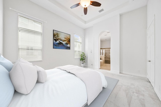 12520 NW 79th Mnr, Parkland, FL 33076 - bedroom featuring a ceiling fan, visible vents, light colored carpet, arched walkways, and connected bathroom