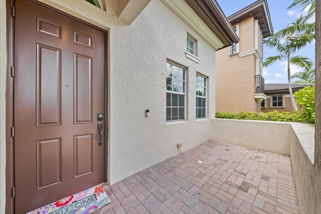 12520 NW 79th Mnr, Parkland, FL 33076 - view of exterior entry featuring a patio and stucco siding