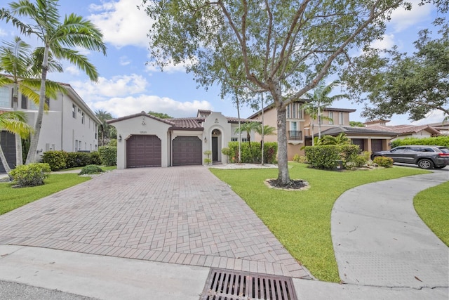 12520 NW 79th Mnr, Parkland, FL 33076 - mediterranean / spanish house with stucco siding, decorative driveway, an attached garage, and a front lawn